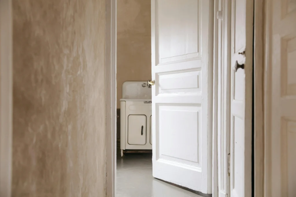 A room with mold growing under the wallpaper