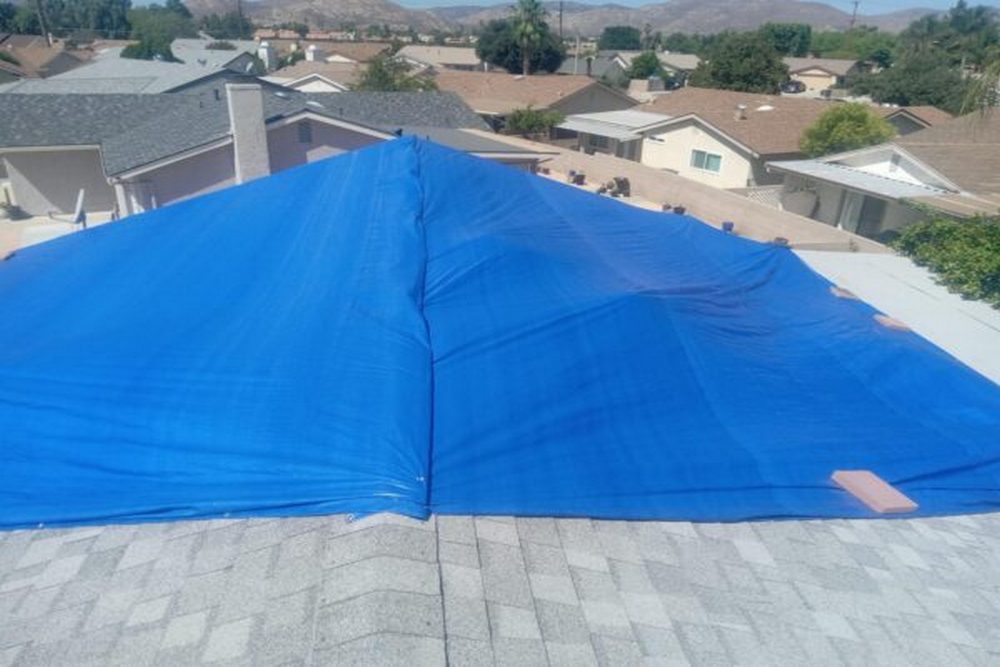 How Roof Tarping Prevents Further Damage After Storms and Fire Incidents